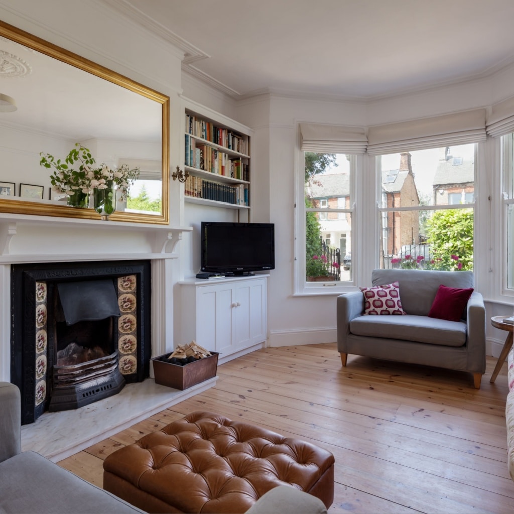 Home interior living room with bay windows and fireplace