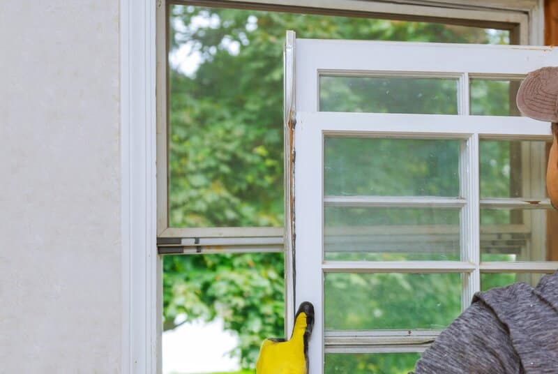 Contractor replacing a broken window