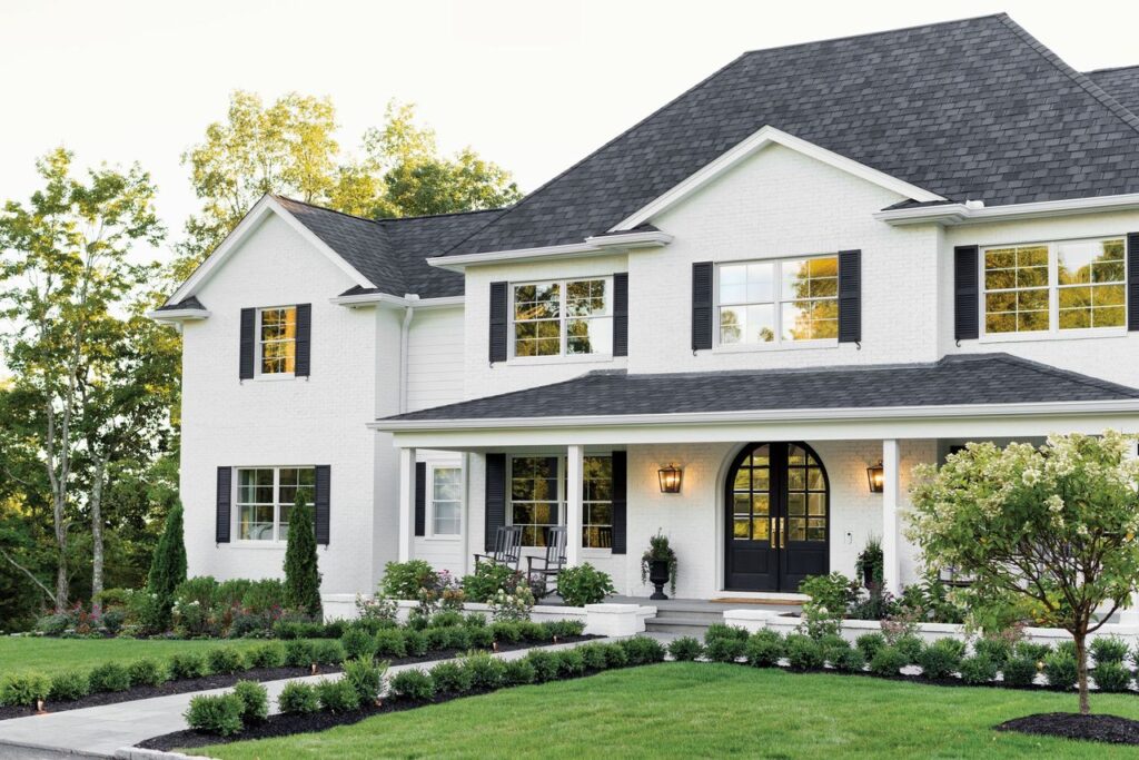 front face and front lawn of large white two-story home